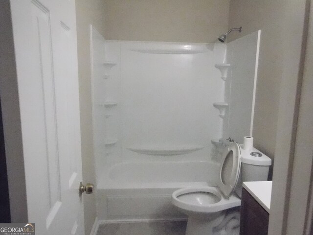 full bathroom with  shower combination, vanity, and toilet