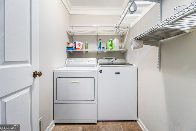 laundry room featuring washing machine and dryer, ornamental molding, and tile patterned flooring