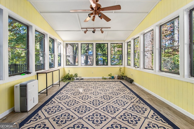 sunroom / solarium with lofted ceiling and ceiling fan