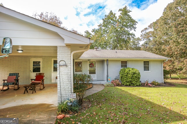 view of front of home with a front lawn and a patio area