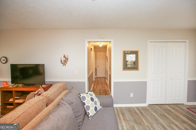 living area featuring wood finished floors and baseboards