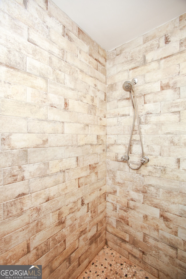 bathroom with tiled shower