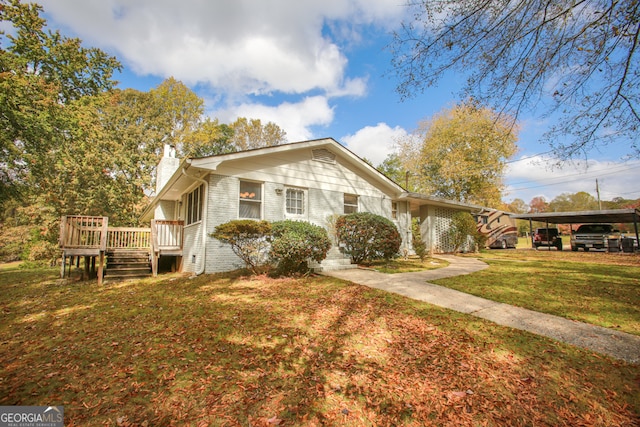 view of front of property with a wooden deck, a carport, and a front lawn