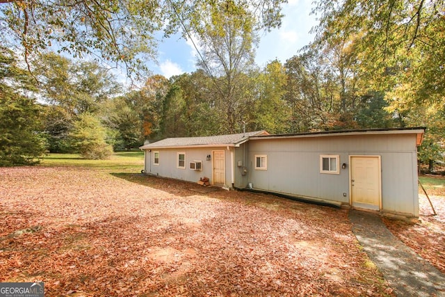 back of property with a wall mounted air conditioner