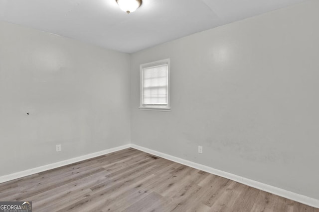 empty room with light hardwood / wood-style floors