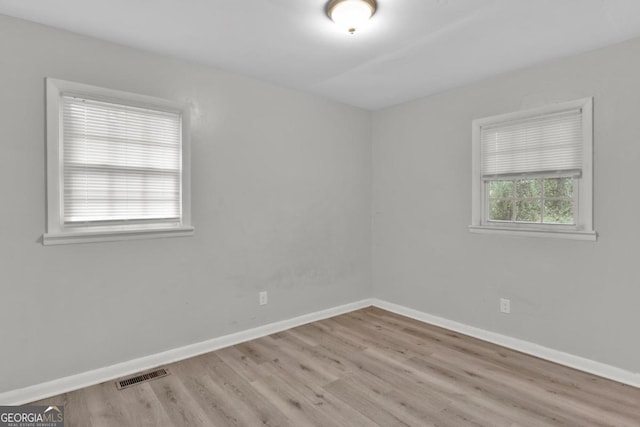 empty room with light hardwood / wood-style flooring