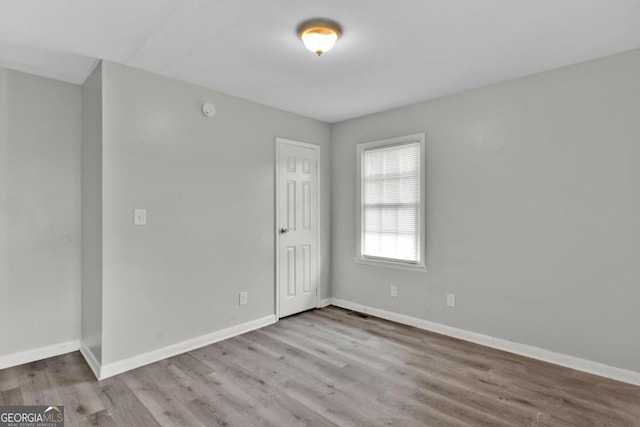 spare room with light hardwood / wood-style flooring