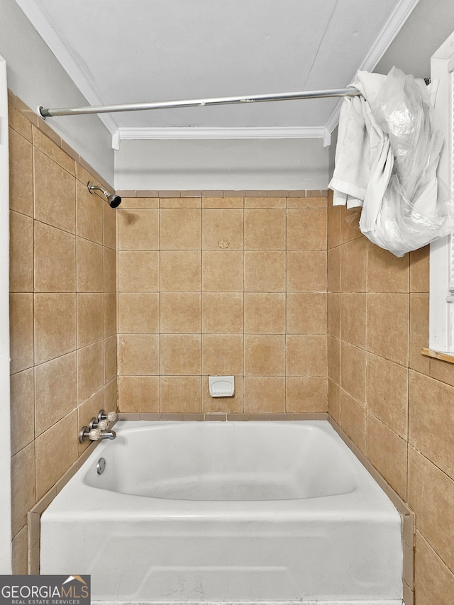 bathroom with tiled shower / bath and crown molding