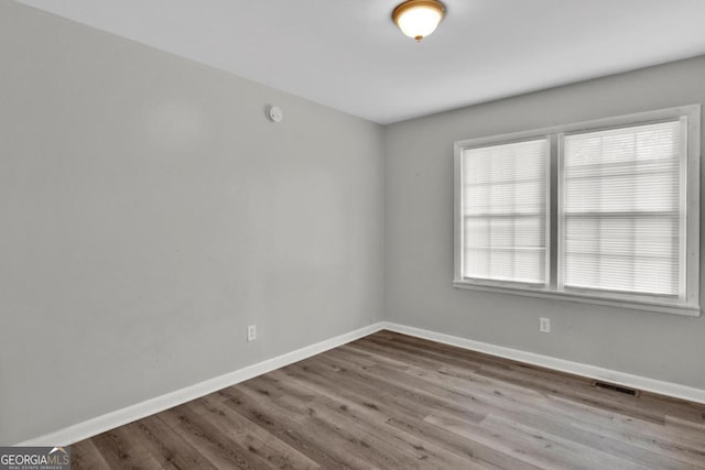 unfurnished room featuring hardwood / wood-style flooring