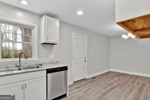 kitchen with white cabinetry, sink, a notable chandelier, stainless steel dishwasher, and light wood-type flooring