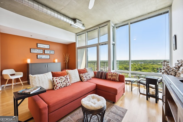 living room featuring light hardwood / wood-style flooring and floor to ceiling windows