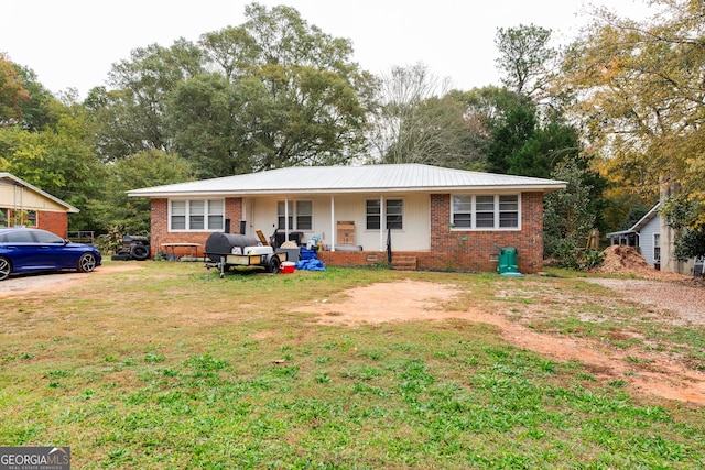 ranch-style home with a porch and a front lawn