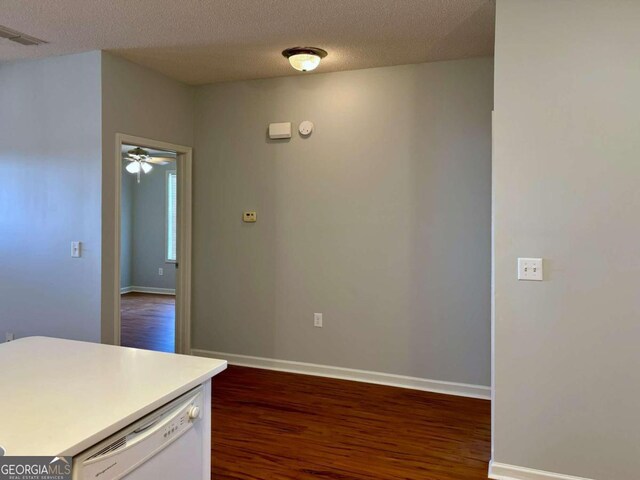 kitchen with ceiling fan, a textured ceiling, dark hardwood / wood-style flooring, and dishwasher