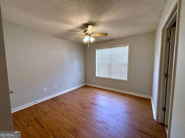 unfurnished bedroom featuring ceiling fan, a textured ceiling, and hardwood / wood-style floors