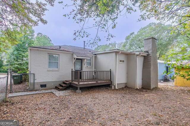 back of property with a wooden deck