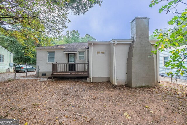 back of house featuring a wooden deck