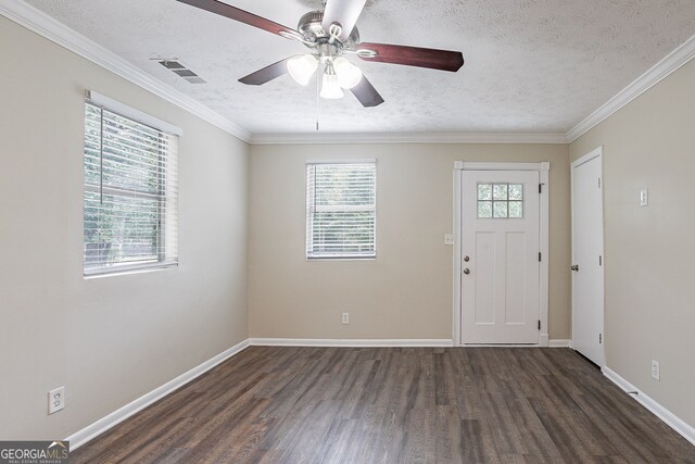 entryway with crown molding, dark hardwood / wood-style floors, a textured ceiling, and ceiling fan