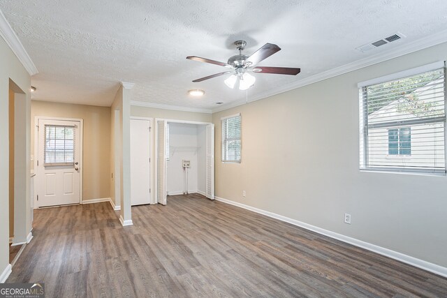 interior space with crown molding, hardwood / wood-style flooring, a textured ceiling, and ceiling fan