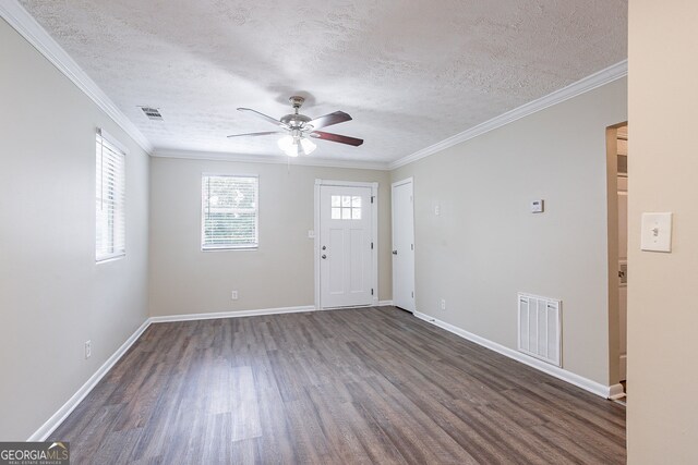 foyer with ornamental molding, ceiling fan, a textured ceiling, and dark hardwood / wood-style flooring