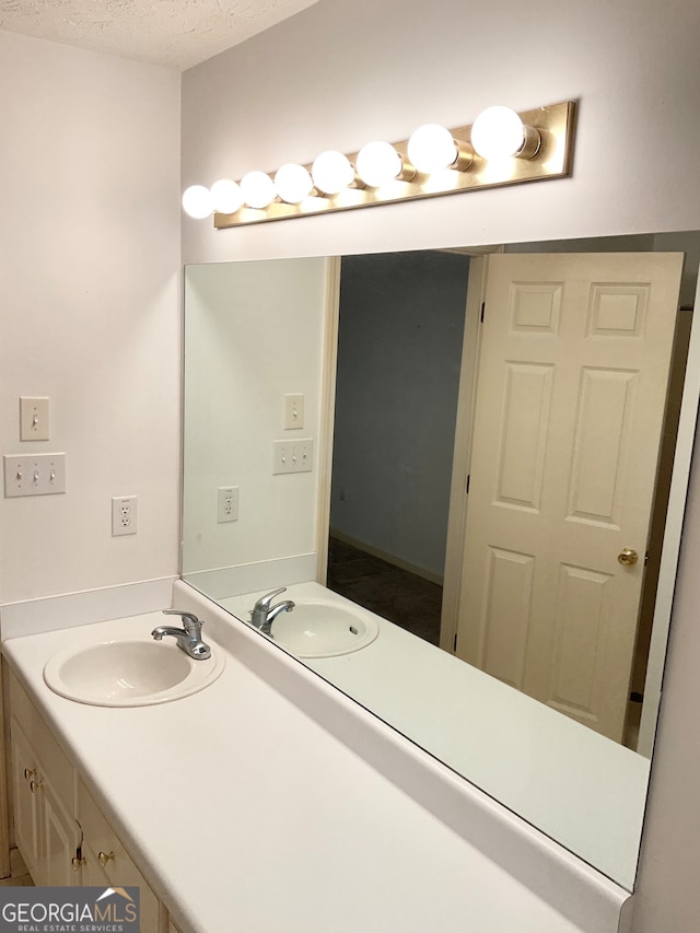 bathroom featuring vanity and a textured ceiling