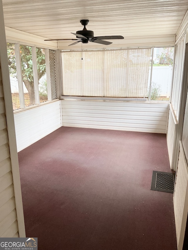 unfurnished sunroom featuring ceiling fan