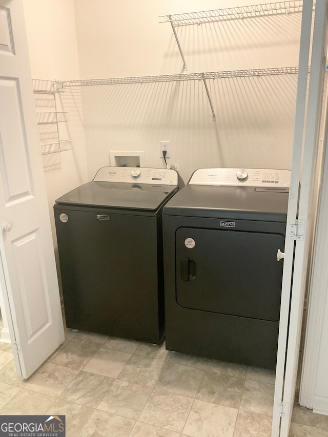 clothes washing area featuring washer and dryer