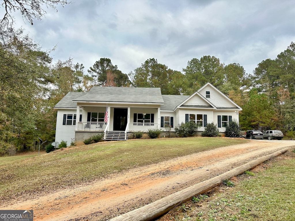 view of front of home with covered porch and a front yard