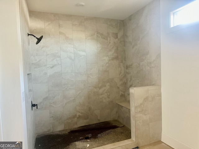 bathroom featuring a tile shower