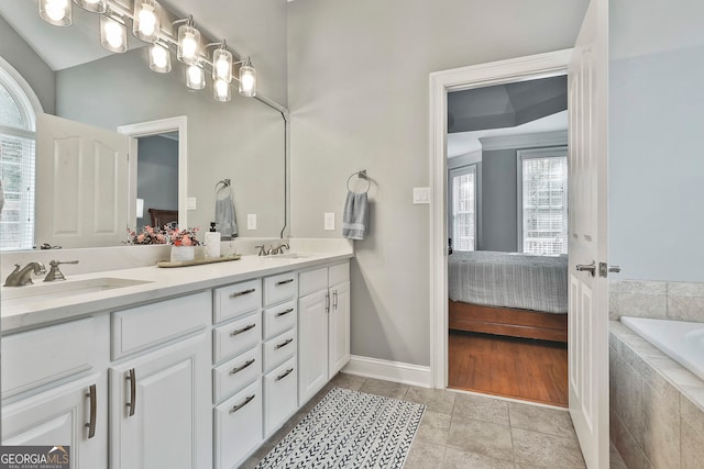 bathroom with vanity, tiled bath, and tile patterned floors