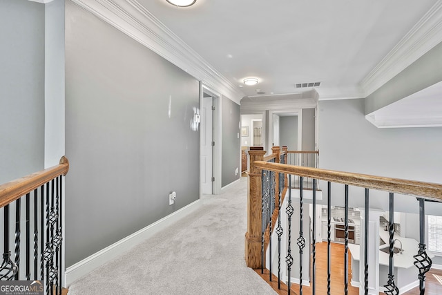 hall featuring light colored carpet and ornamental molding