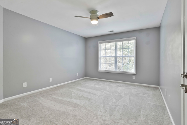 empty room featuring light carpet and ceiling fan