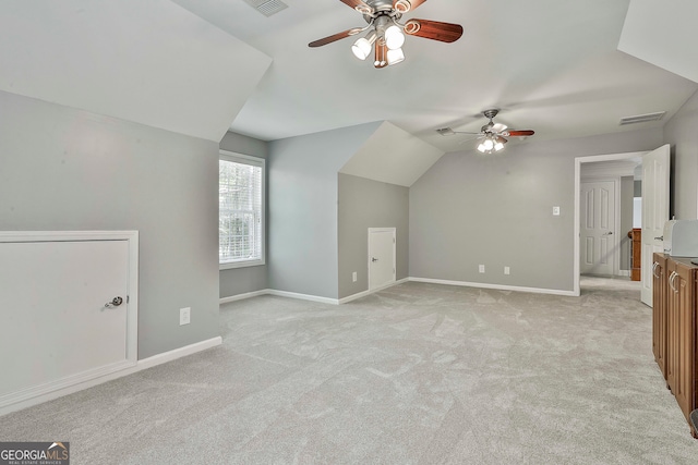 bonus room featuring light colored carpet, ceiling fan, and vaulted ceiling