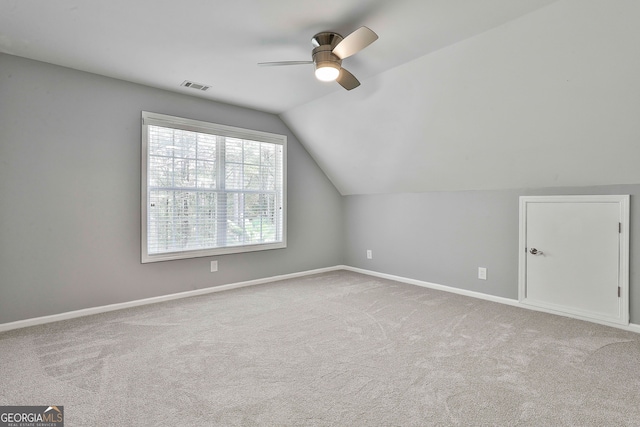 bonus room featuring light colored carpet, ceiling fan, and vaulted ceiling