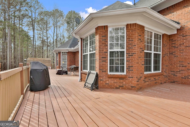 wooden terrace featuring a grill