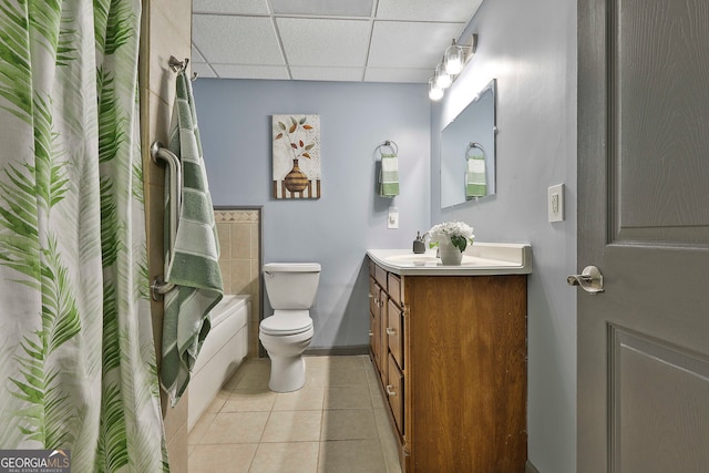 full bathroom featuring shower / bath combo, toilet, tile patterned floors, a paneled ceiling, and vanity