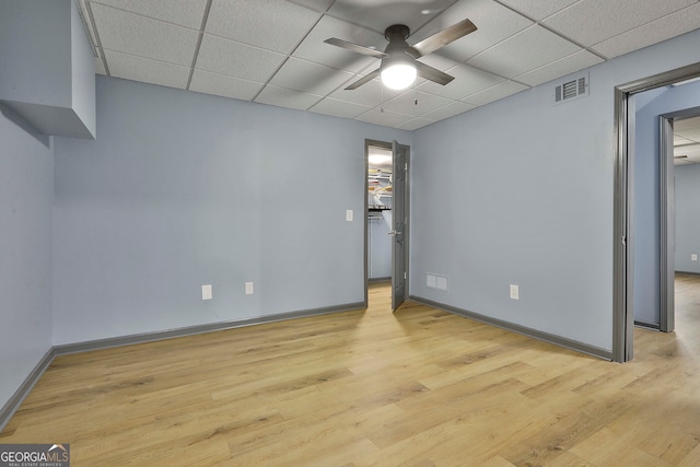 unfurnished room with light hardwood / wood-style flooring, a paneled ceiling, and ceiling fan