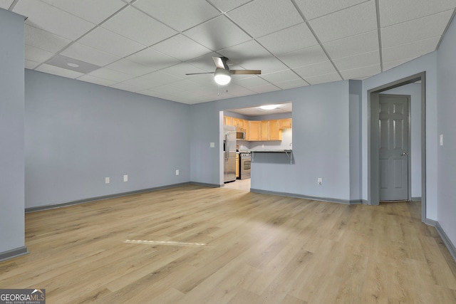 unfurnished living room with a paneled ceiling, light wood-type flooring, and ceiling fan