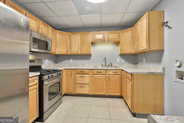 kitchen featuring light tile patterned flooring, a paneled ceiling, sink, appliances with stainless steel finishes, and light brown cabinets