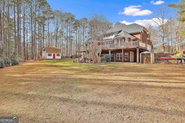 rear view of property with a deck, a yard, and a storage shed