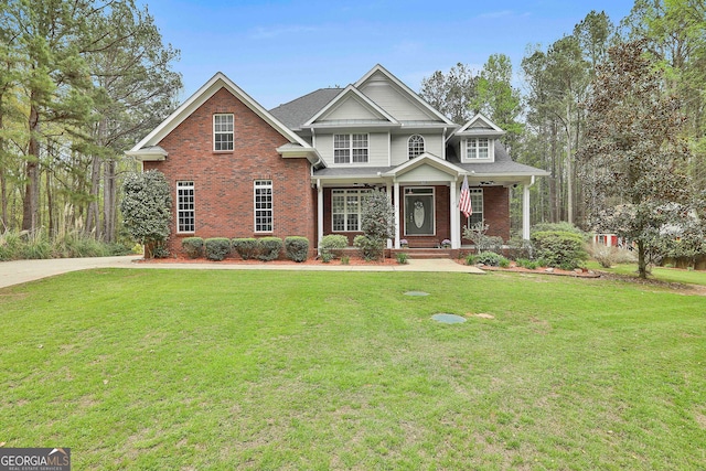 view of front of property with a front yard and covered porch