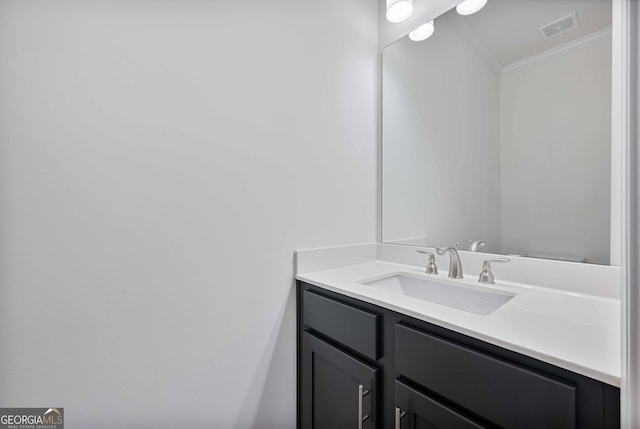 bathroom with crown molding and vanity