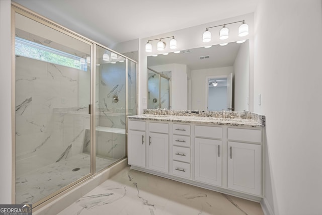 bathroom featuring vanity and a shower with door