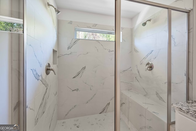 bathroom featuring vanity and tiled shower