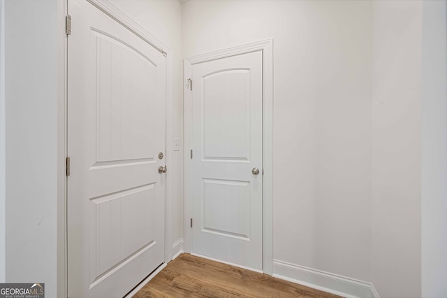 doorway with hardwood / wood-style flooring