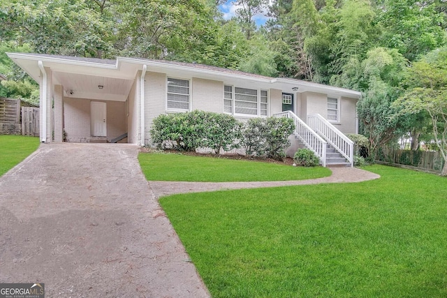 ranch-style house featuring a carport and a front lawn