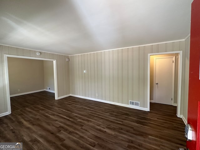 interior space featuring crown molding and dark hardwood / wood-style floors