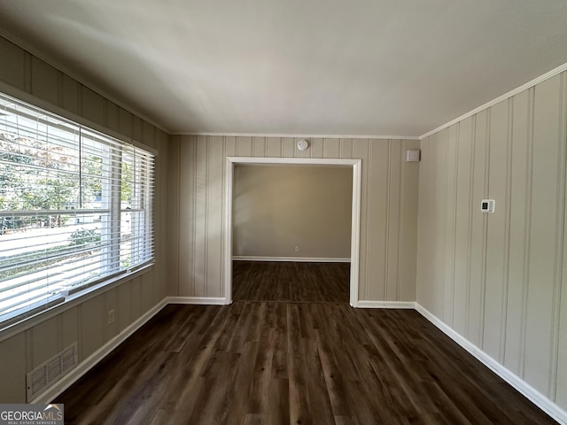 2425 Hanford Dr SW, Atlanta, GA 30315 - empty room featuring dark wood-style floors, a decorative wall, crown molding, and baseboards