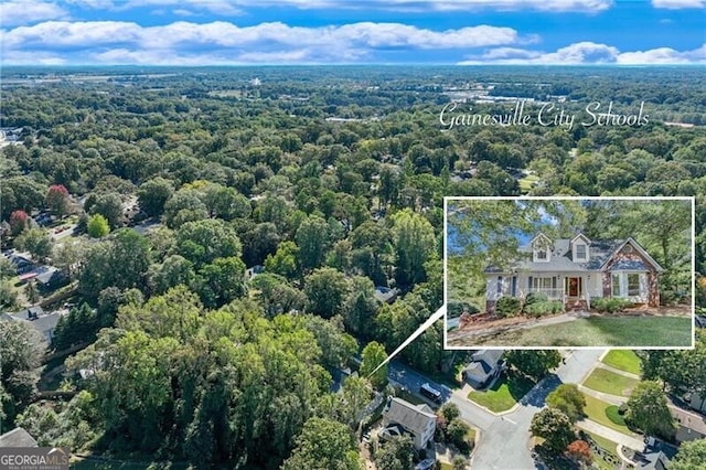 aerial view of property and surrounding area with property parcel outlined and a forest