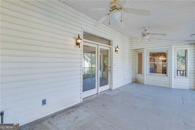 unfurnished sunroom featuring ceiling fan