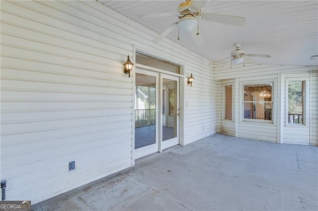 unfurnished sunroom featuring a ceiling fan
